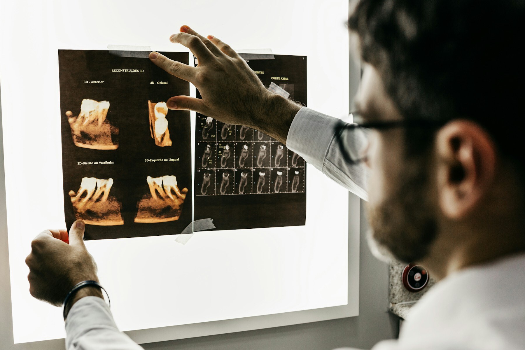 A dentist reviewing dental X-rays