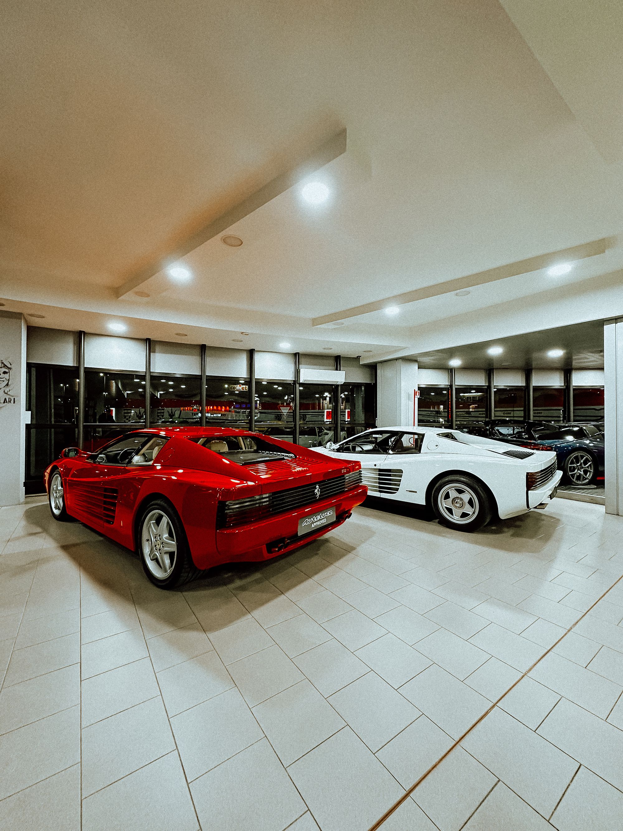 Classic sports cars inside a warm showroom