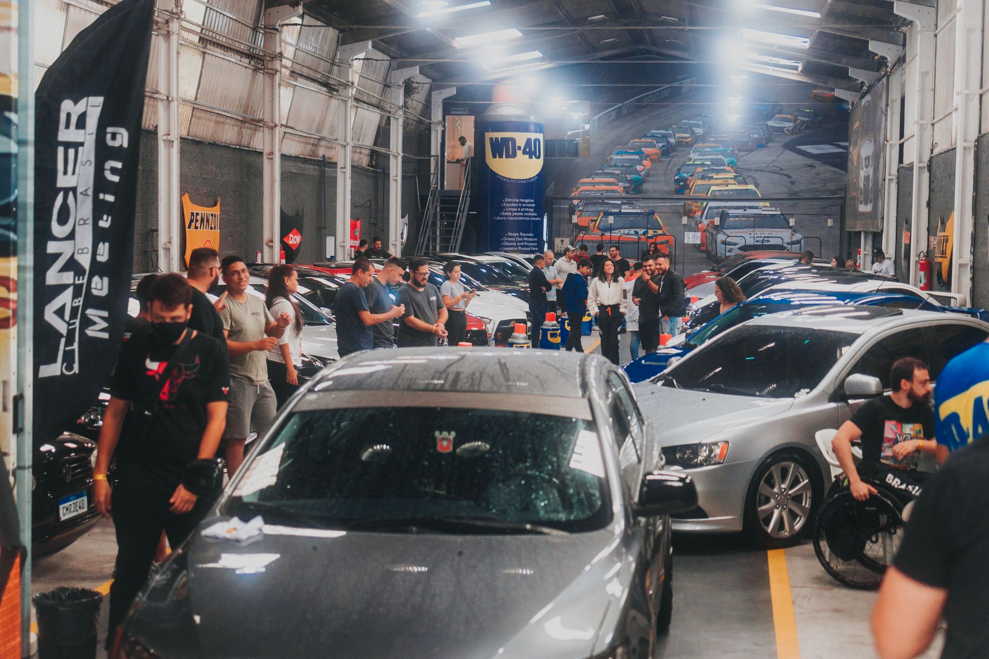 People gathered around cars at a Cars and Coffee morning
